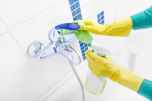 Cleaning team handling a carpet stain treatment safely